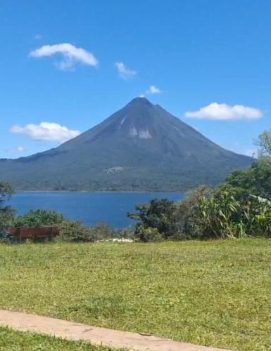 a mountain with a lake in front of it at Arenal Base Camp in El Castillo de La Fortuna