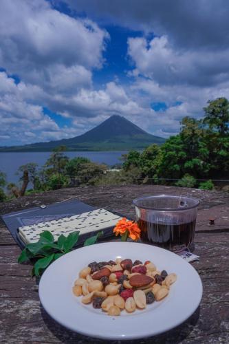 a plate of food on a table with a drink at Arenal Base Camp in El Castillo de La Fortuna