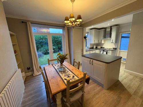 a kitchen with a wooden table and a dining room at The Nordic Nook - 3 bedroom house plus double sofabed in York