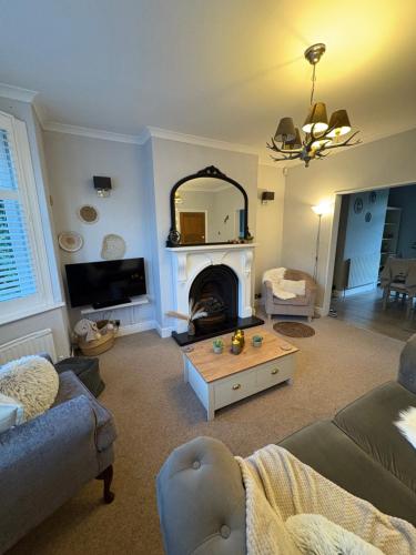 a living room with a couch and a fireplace at The Nordic Nook - 3 bedroom house plus double sofabed in York