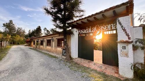 a street with a building with a sign on it at Posada Campestre La Casona in Villa de Leyva