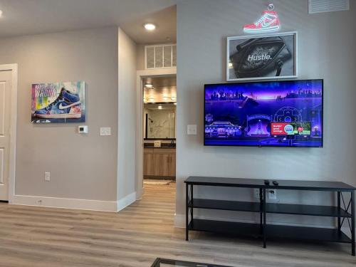 a living room with a tv on a wall at Beautiful 1BR - Fitness & Pool in Austin