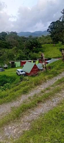 a car parked in a field next to a road at Arenal Base Camp in El Castillo de La Fortuna