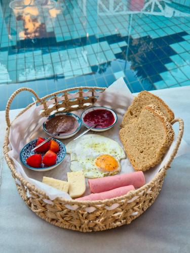 a basket of food with eggs bread and toast at Sea Sun in Plomarion