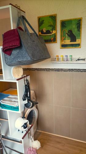 a bathroom with a shelf with a toilet and some pictures at Etappe 17 - am Kylltal Radweg in Birgel