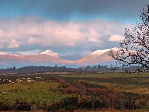 a view of snow covered mountains in a field at FINN VILLAGE - Loch Lomond Sunset Glamping Pod - Private Ofuro HOT TUB in Drymen