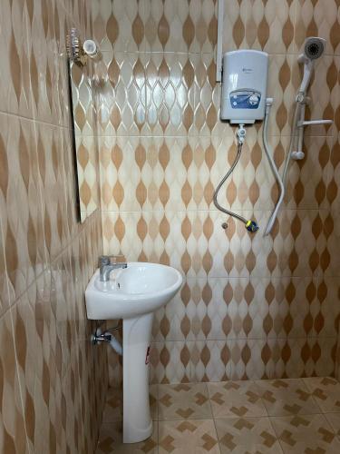a bathroom with a sink and a shower stall at R Kelly Tanzania in Arusha