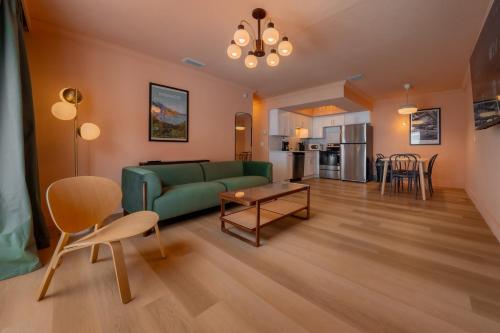 a living room with a green couch and a table at Monaco Vacation Rentals in Clearwater Beach