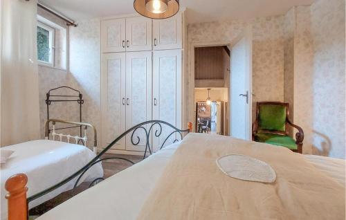 a bedroom with a bed and a chair at Pet Friendly Home In Touffreville in Touffreville
