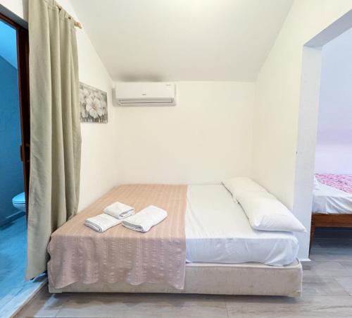 a bedroom with a bed with two towels on it at The Garden Tiny Homes in Ayvacık