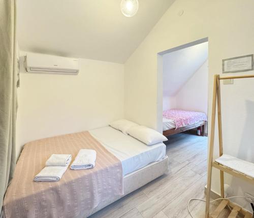 a bedroom with a bed with two towels on it at The Garden Tiny Homes in Ayvacık