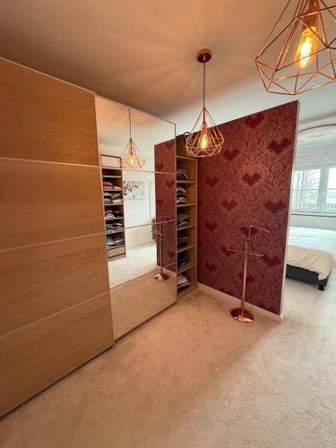 a room with wooden cabinets and a bedroom with a bed at Idyllisches Dorfhaus vor Usedom in Gützkow