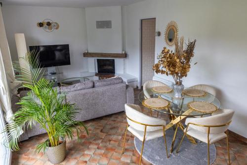 a living room with a couch and a table and chairs at Maison près de Disneyland in Saint-Germain-sur-Morin