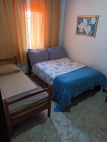 Ένα ή περισσότερα κρεβάτια σε δωμάτιο στο Hostel Palhoça