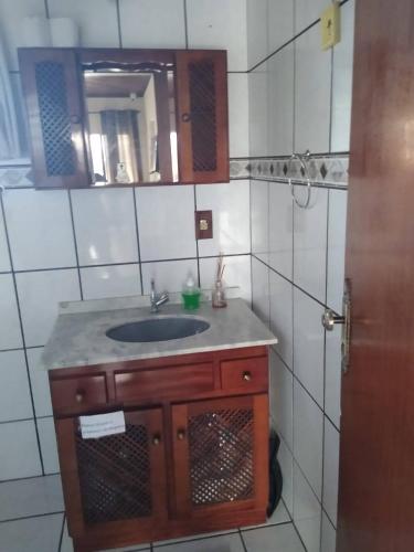 a bathroom with a sink and a mirror at Hostel Palhoça in Palhoça