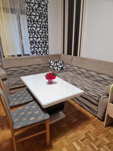 a living room with a couch and a table at apartma-sobe Lejla in Vipava