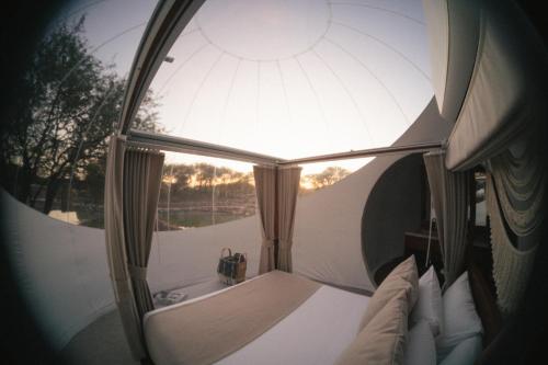 a room with a window and a bed with pillows at Campera Hotel Burbuja in San Miguel de Allende