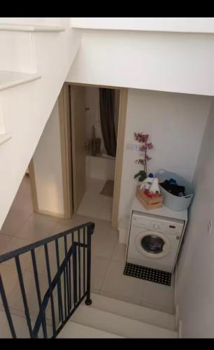 a staircase with a washing machine in a room at MERAKI Villa in Paralimni