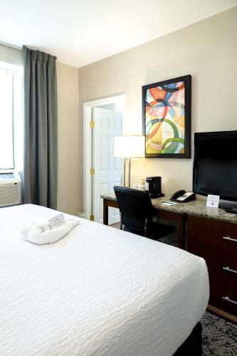 a hotel room with a bed and a desk at Quality Inn & Suites in Vancouver