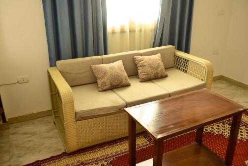 a living room with a couch and a table at Flamingo Boutique hotels in Luxor