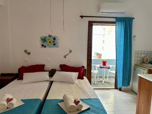 a bedroom with a bed with towels on it at BONATSA ROOMS in Palaiochóra