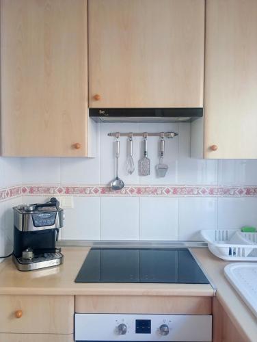 a kitchen with a sink and a stove top oven at Astrid-Luise Huss in Puerto de Mazarrón