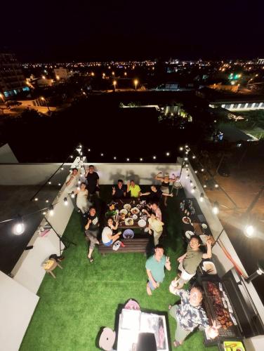 a group of people sitting around a table at night at Hermit Crab Guesthouse in Hengchun