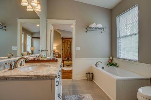 a bathroom with two sinks and a tub and a tub at 6BR Modern Farmhouse Retreat in Franklin
