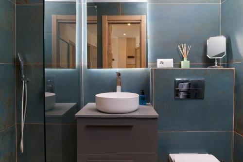 a bathroom with a sink and a mirror at Harbor Luxury - Apartment By Tarifa Rent in Tarifa