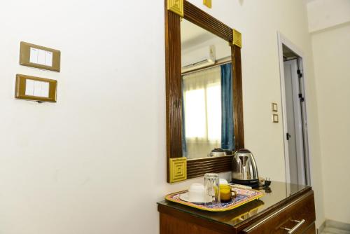 a bathroom with a mirror and a sink at Flamingo Boutique hotels in Luxor