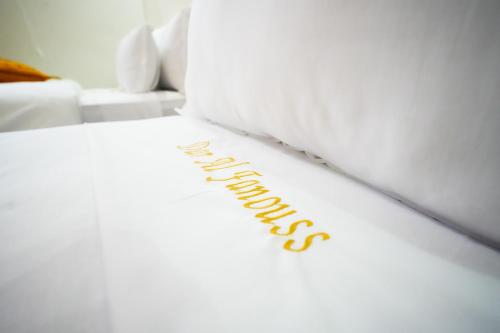 a white bed with the word happiness written on it at Dar Al Fanouss in Rabat