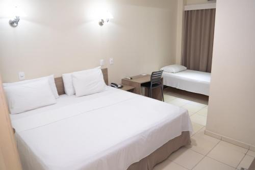 Кровать или кровати в номере Amazônia Palace Hotel