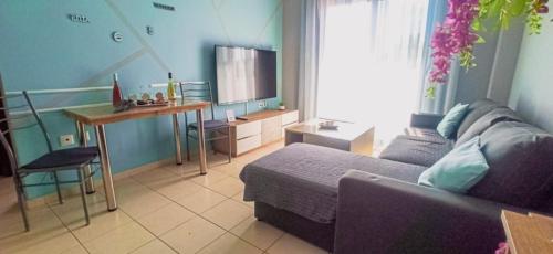 a living room with a couch and a table at VSM View Sea and More in Nea Chili