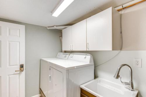 a laundry room with a washer and a sink at Near Shops and Eats Elegant Home in Wheat Ridge! in Wheat Ridge