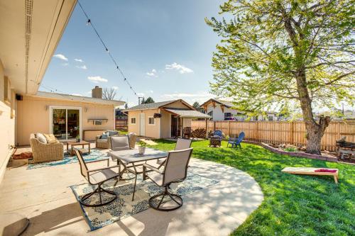 a patio with a table and chairs in a yard at Near Shops and Eats Elegant Home in Wheat Ridge! in Wheat Ridge