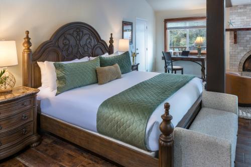 a bedroom with a large bed and a desk at Arch Cape Inn and Retreat in Arch Cape