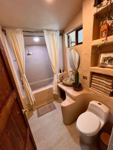 a bathroom with a toilet and a sink and a tub at Casa Nutabe - Casa de Campo en Girardota cerca a Medellín in Girardota
