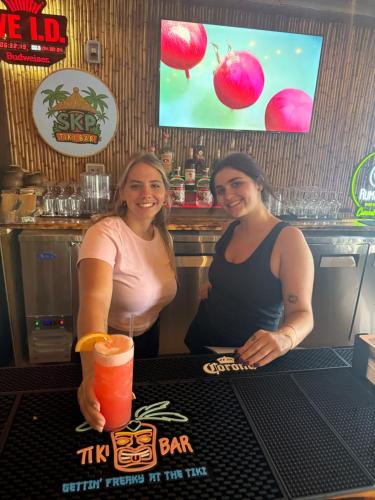 two women standing at a bar with a drink at Siesta Key Palms Resort in Sarasota