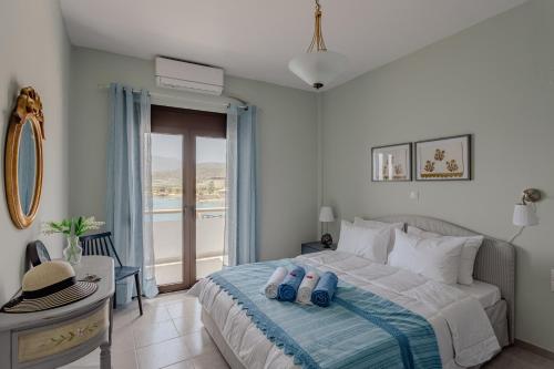 a bedroom with a bed and a window with a view at Eclectic Vintage Apartment- Sea View Perfection, Hersonissos, Crete in Limín Khersonísou