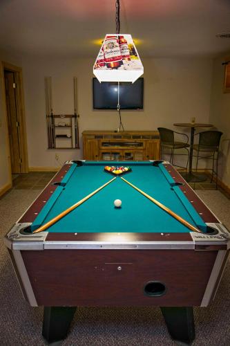a room with a pool table with a ball on it at Hilltop on Keuka 
