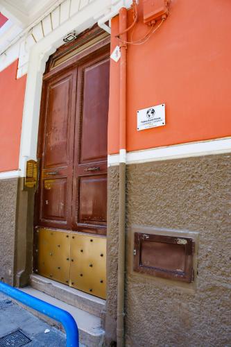 a large wooden door on the side of a building at Futura Guest House in Bari