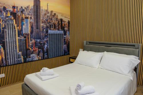 a bedroom with a large bed with two towels on it at Futura Guest House in Bari