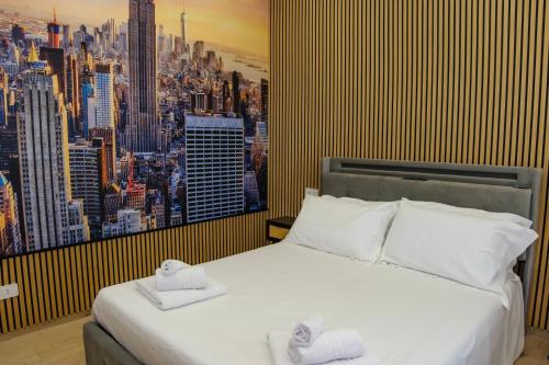 a bedroom with a large bed with two towels on it at Futura Guest House in Bari