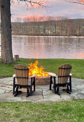 two chairs around a fire pit in a park at Lodge on Lamoka 