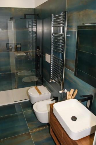 a bathroom with a toilet and a sink and a shower at Futura Guest House in Bari