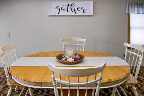 a dining room table with white chairs and a white table at Lodge on Lamoka 