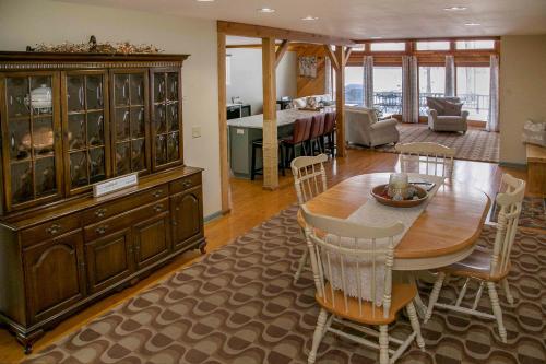 a living room with a dining table and a large cabinet at Lodge on Lamoka 