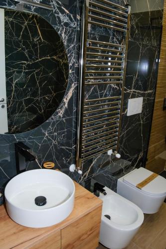 a bathroom with a white sink and a toilet at Futura Guest House in Bari
