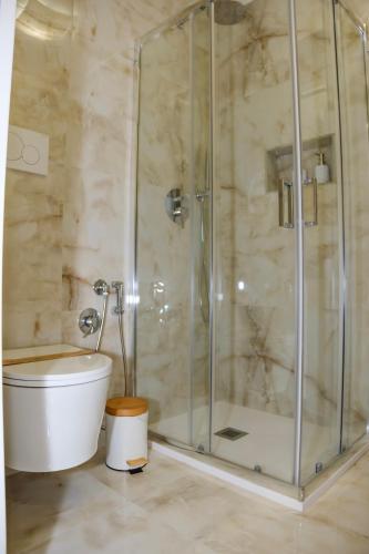 a bathroom with a toilet and a glass shower at Futura Guest House in Bari