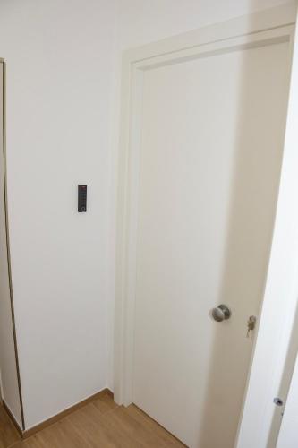 a white door in a room with white walls at Futura Guest House in Bari